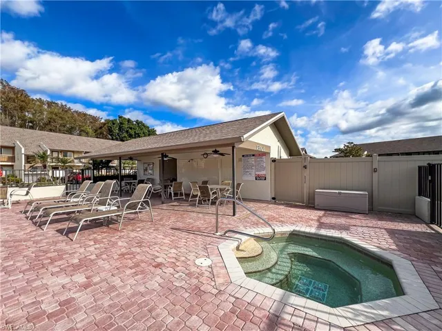 View of pool featuring a hot tub, a patio, and ceiling fan