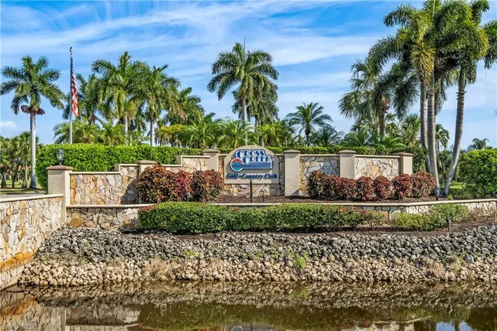 Community / neighborhood sign featuring a water view