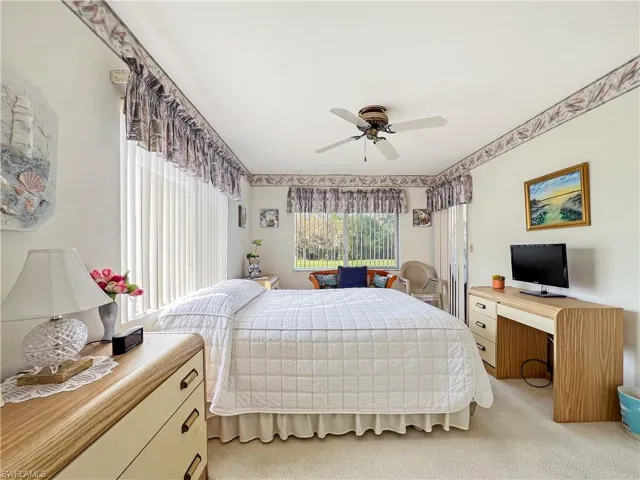 Bedroom featuring ceiling fan and light colored carpet