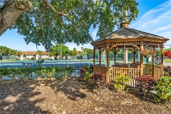 View of home's community featuring a gazebo and tennis court