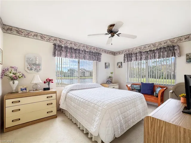 Carpeted bedroom with ceiling fan