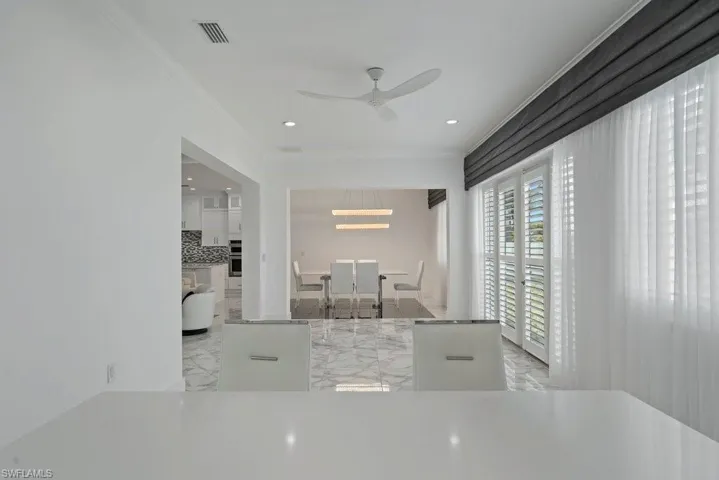 White interior featuring crown molding and recessed lighting