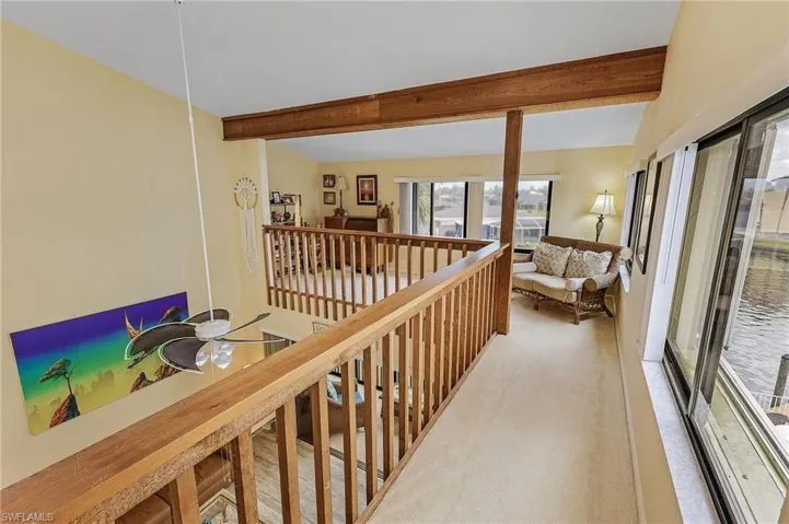 Hall with carpet and beam ceiling