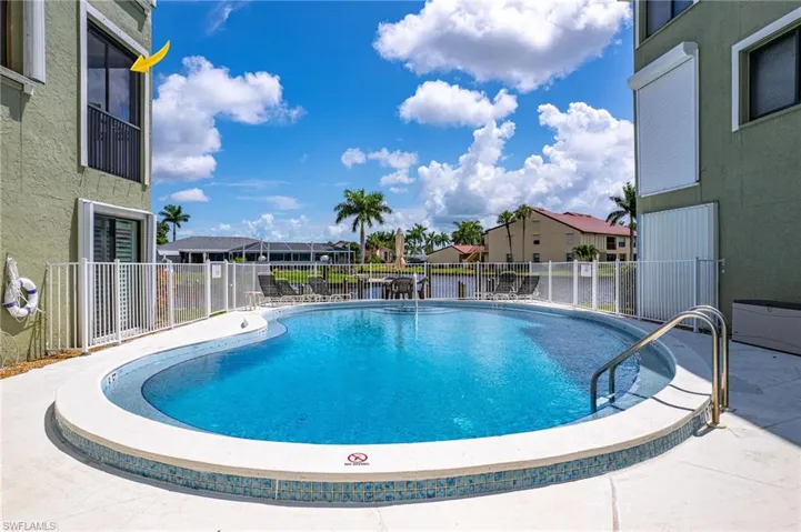 Pool with fence, a residential view, and a patio