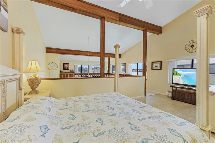 Tiled bedroom featuring high vaulted ceiling, baseboards, and beamed ceiling