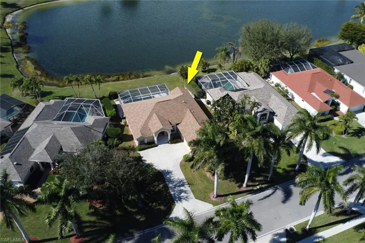 Aerial perspective of suburban area featuring a nearby body of water