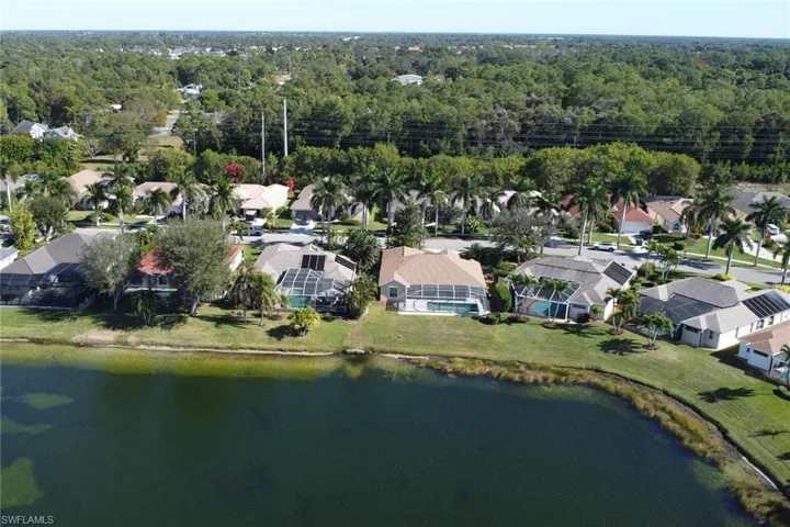 Aerial view of property's location featuring nearby suburban area and a nearby body of water