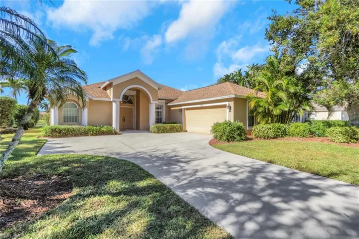 Mediterranean / spanish house featuring stucco siding, concrete driveway, an attached garage, a front yard, and a shingled roof