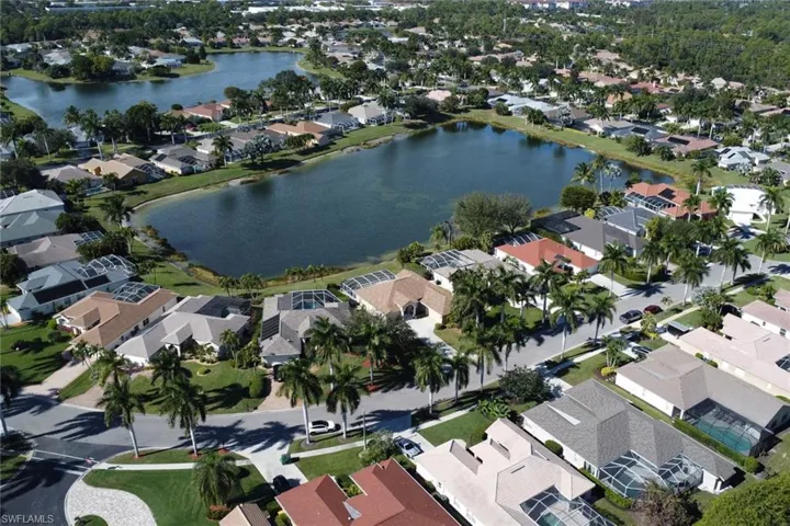 Aerial view of property's location featuring nearby suburban area and a large body of water