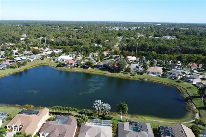 Aerial overview of property's location featuring a nearby body of water and nearby suburban area