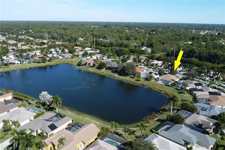 View of property location featuring a large body of water and nearby suburban area