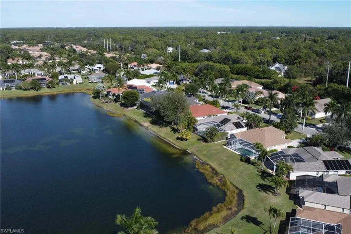 Aerial overview of property's location featuring a nearby body of water and nearby suburban area