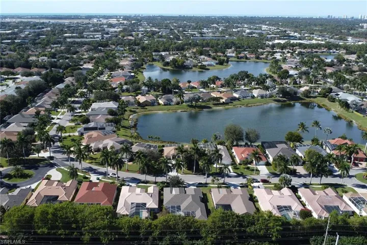 Aerial overview of property's location with nearby suburban area and a nearby body of water