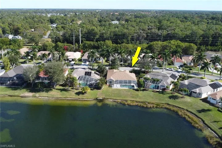 Aerial view of property's location with nearby suburban area and a nearby body of water