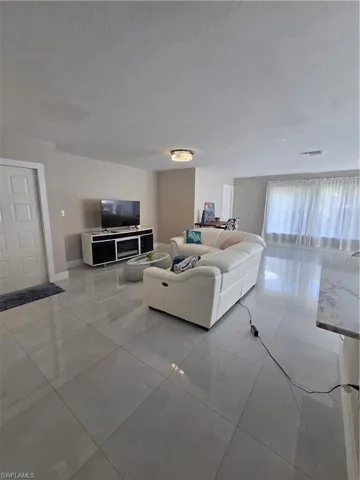 Living room featuring light tile patterned floors