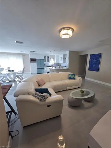 Tiled living area featuring baseboards