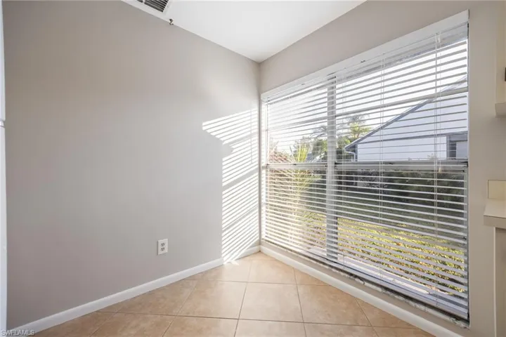 Unfurnished room featuring light tile patterned floors and baseboards