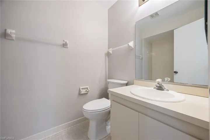 Full bathroom featuring vanity, light tile patterned floors, and a shower