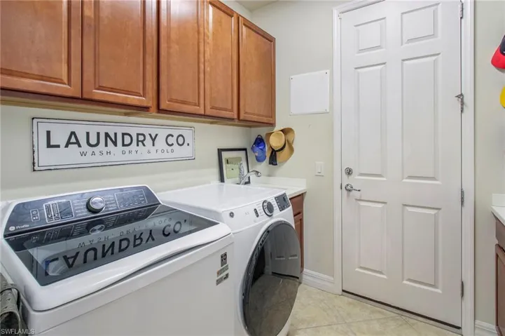 With utility sink, cabinets, and folding table