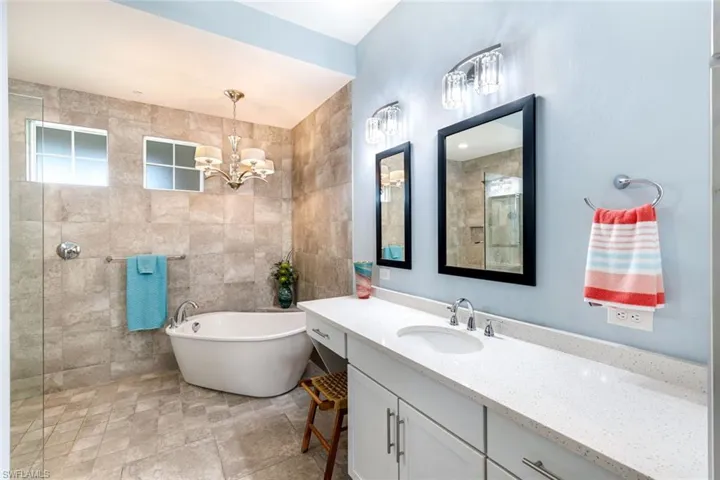 Spa inspired primary bathroom with stunning free standing soaking tub