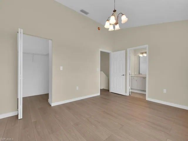 This is the primary bedroom, featuring a spacious and desirable walk-in closet for optimal storage and organization.