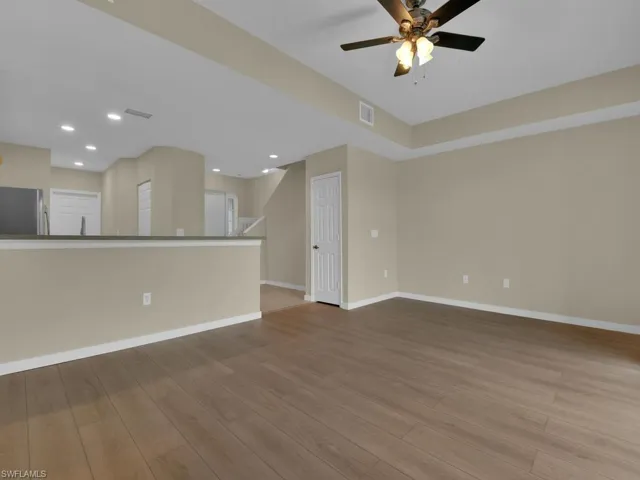 Living room with ceiling fan and newly installed LVP flooring