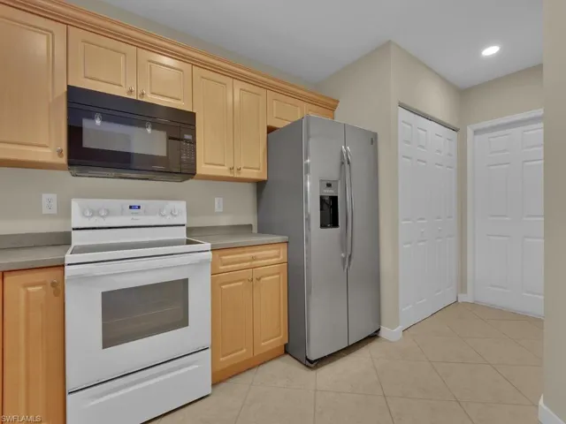 Kitchen with stainless steel refrigerator