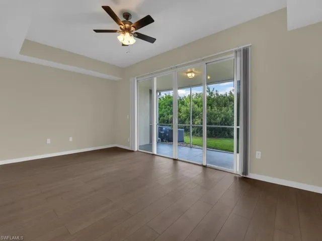 Spacious Living Room featuring elegant sliding glass doors that seamlessly connect the interior to a delightful Lanai, perfect for relaxation and entertainment.