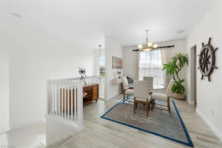 Dining room featuring a chandelier and light wood-type flooring