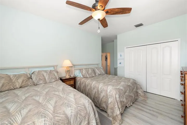 Bedroom featuring a closet, a ceiling fan, and wood finished floors