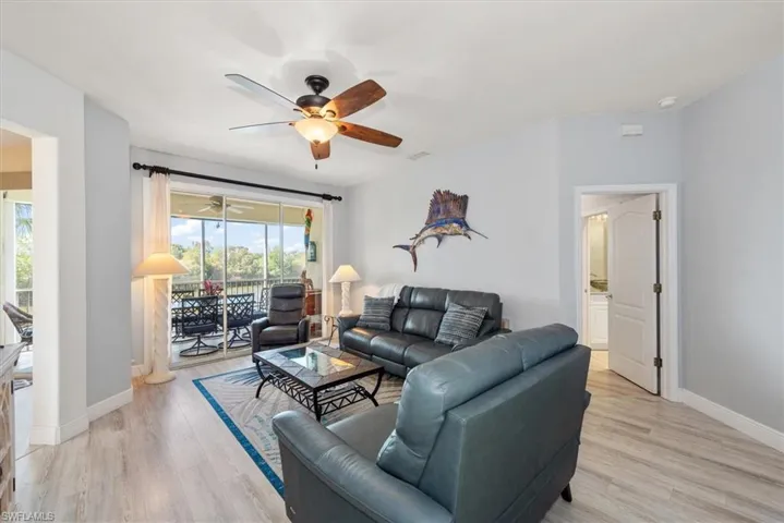 Living area featuring light wood-type flooring and a ceiling fan