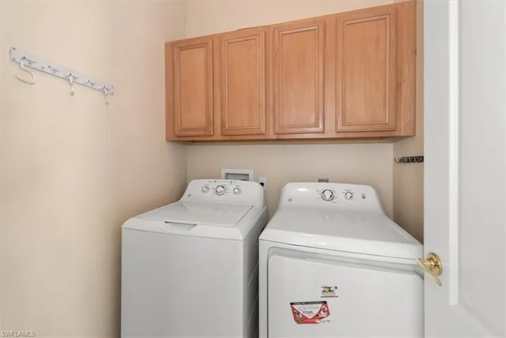 Laundry area with washer and clothes dryer and cabinet space