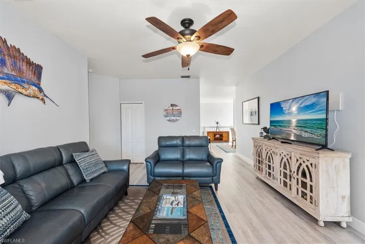 Living room with wood finished floors and ceiling fan