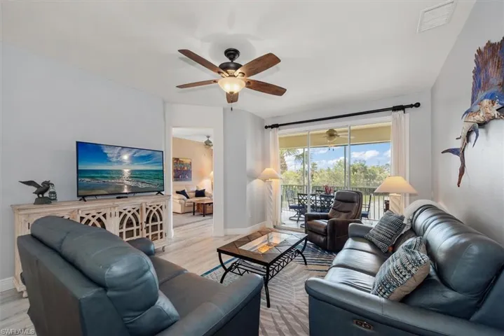 Living room with light wood-style flooring and ceiling fan
