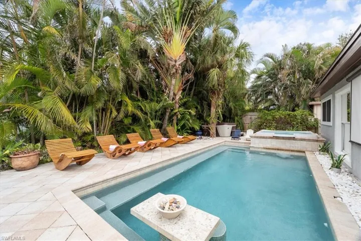 View of swimming pool featuring an in ground hot tub