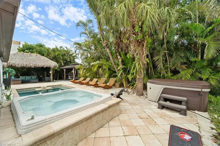 View of pool featuring a gazebo, a patio area, and an outdoor hot tub