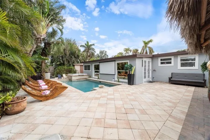 View of swimming pool featuring a jacuzzi, french doors, and a patio