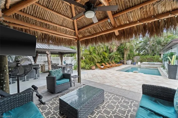 View of patio / terrace featuring a gazebo, ceiling fan, an outdoor kitchen, and an outdoor hangout area