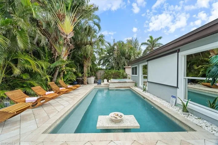 View of swimming pool with an in ground hot tub