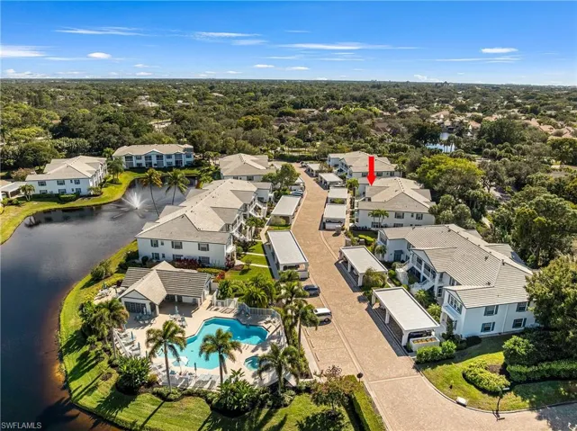 Aerial perspective of suburban area with a large body of water and a pool