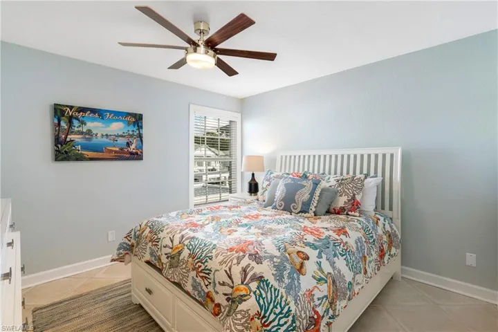 Bedroom with a ceiling fan and light tile patterned floors
