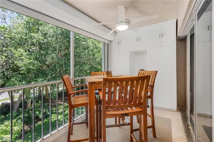 Dining space featuring light tile patterned floors, a ceiling fan, and a textured ceiling