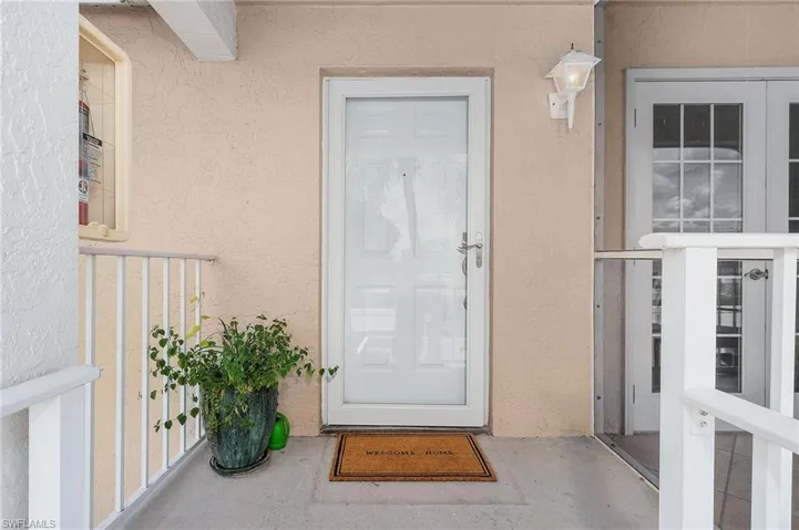 View of exterior entry featuring stucco siding