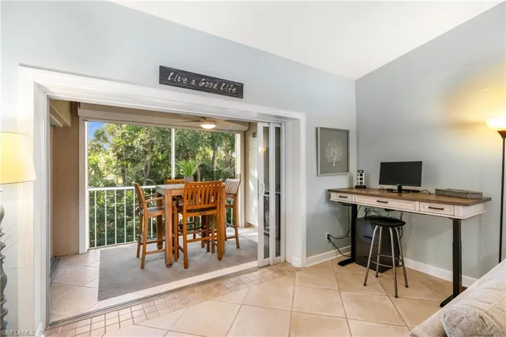 Dining area featuring light tile patterned flooring, a desk, and ceiling fan