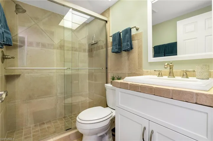 Bathroom with vanity and a stall shower