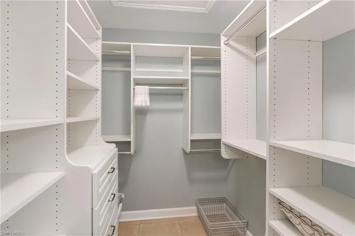 Walk in closet with light tile patterned flooring
