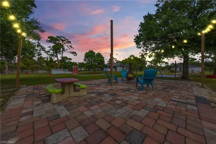 Patio terrace at dusk featuring a patio and an outdoor fire pit