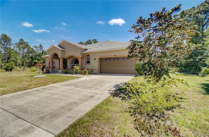View of front of home featuring a garage and a front yard