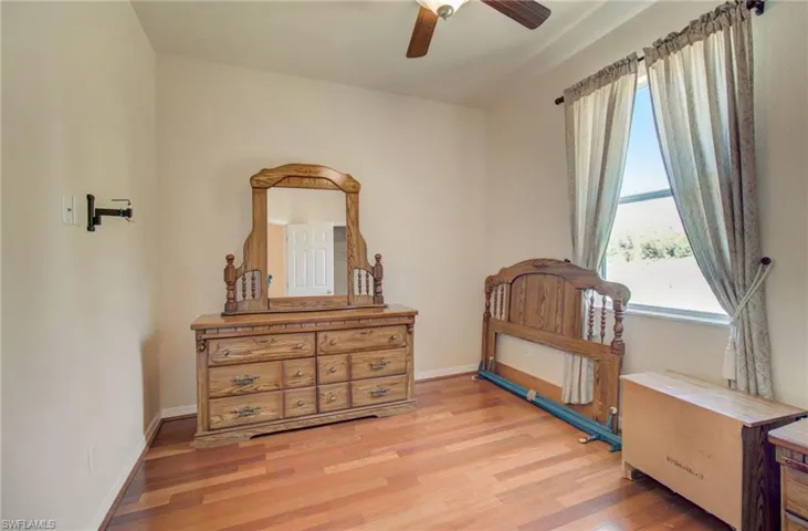 Bedroom featuring ceiling fan and light wood-type flooring