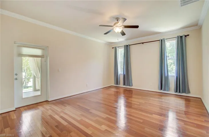 Unfurnished room featuring ceiling fan, light hardwood / wood-style floors, crown molding, and a wealth of natural light